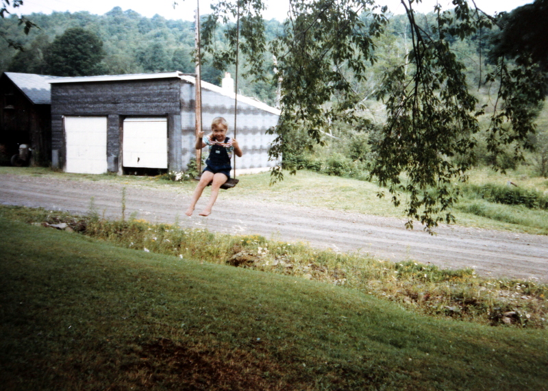 Being adopted, a picture of me as a little girl on an old swing