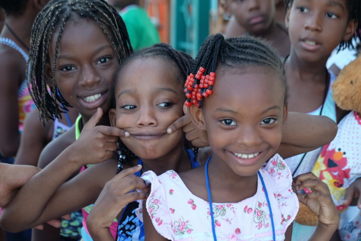 Children in Haiti huddle for a photo. 