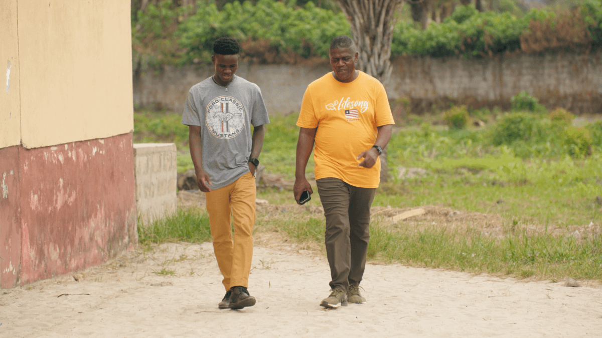 Jerry walks with his mentor, Lifesong Director Emmanuel Jones